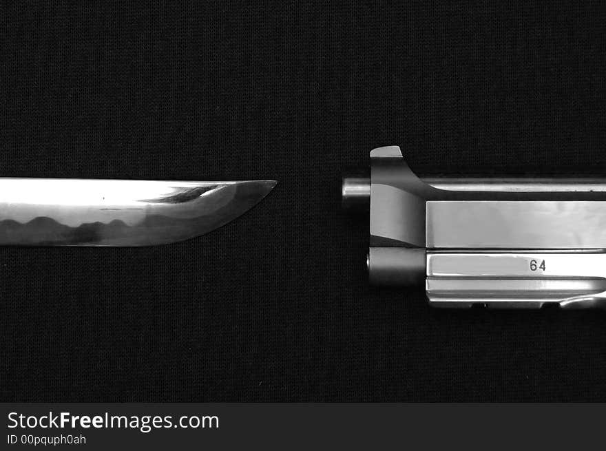 Knife And Gun Pointing Towards Each Other