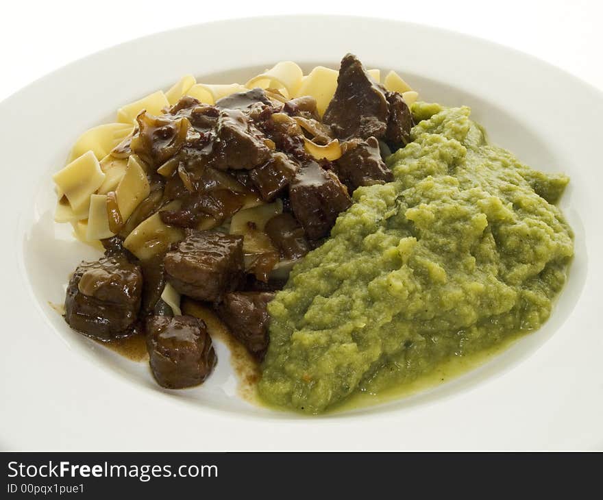 Goulash with savoy and noodles on a white plate