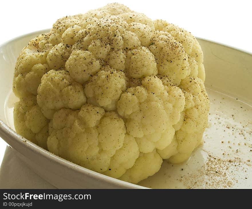 Head of boiled cauliflower on a white plate