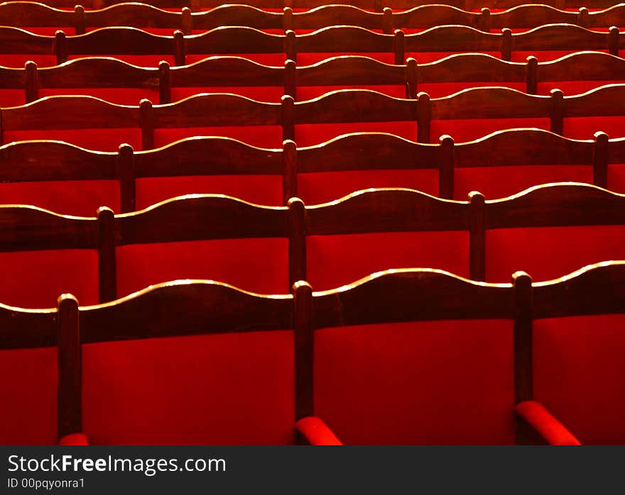 Red theatrical armchairs in a retro style