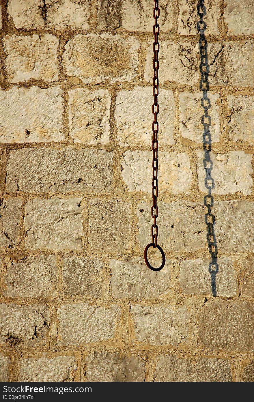 Brick wall background with rusty chain and shadow