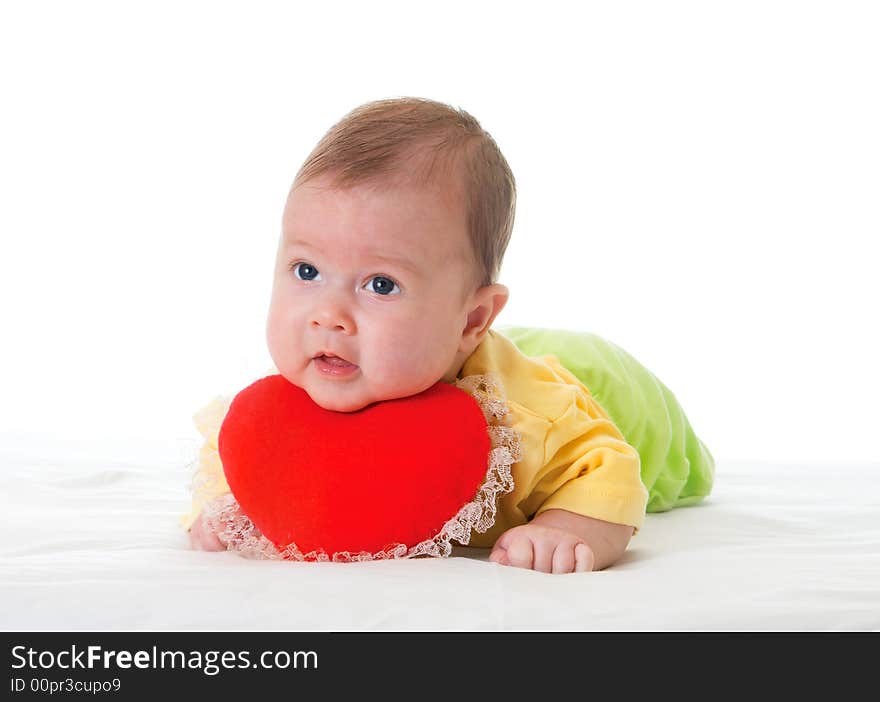 Baby with a soft toy in the form of heart over white