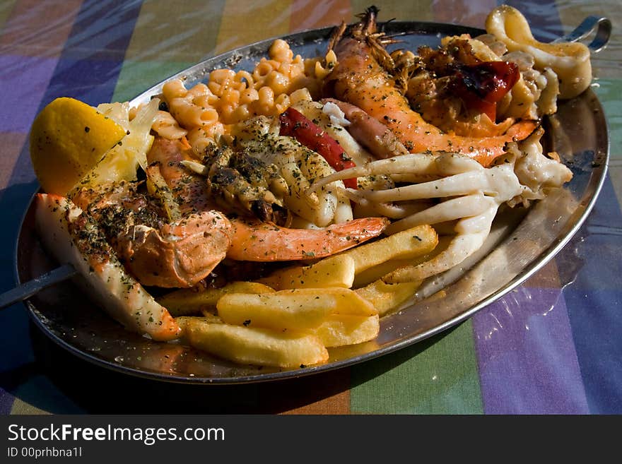 Seafood Kebab with French fries and macaroni.