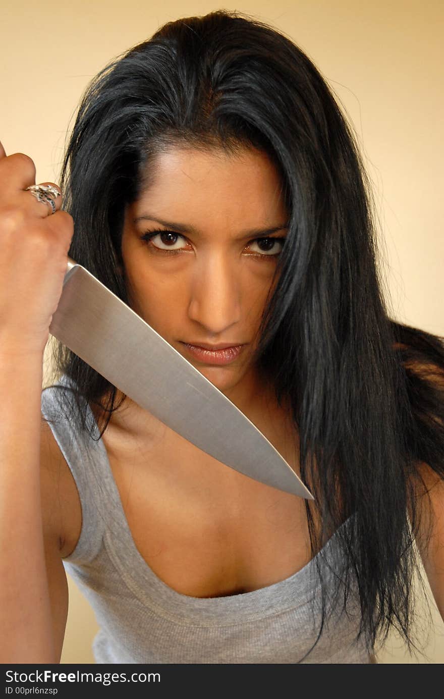 Asian woman holding large knife. Asian woman holding large knife