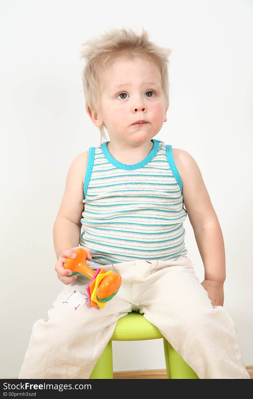 The boy on chair with toy