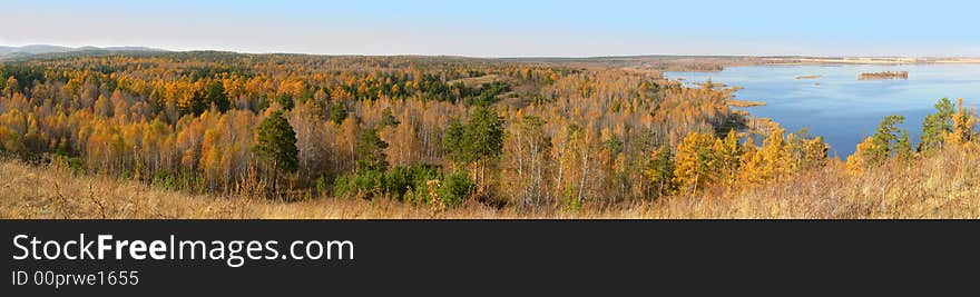 Autumn wood in the neighbourhood with lake. Panoramic view. Autumn wood in the neighbourhood with lake. Panoramic view.