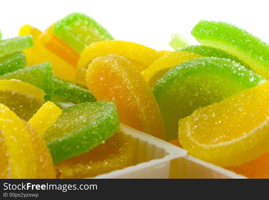 Close-up of colourful fruit candies over white