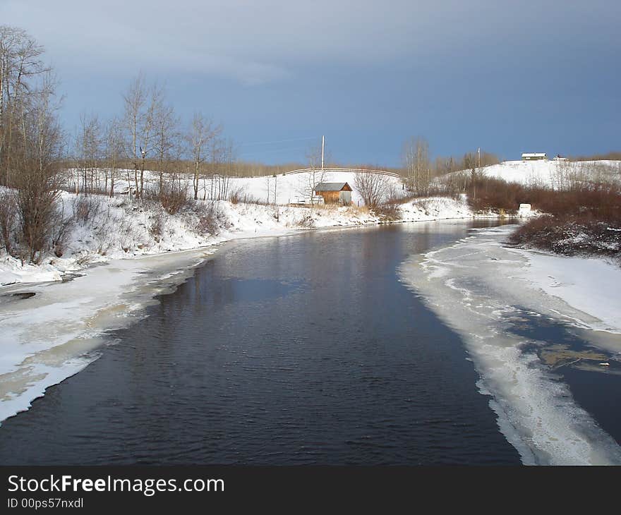 Creek waters flowing under the bridge on a cold winter's day. Creek waters flowing under the bridge on a cold winter's day.