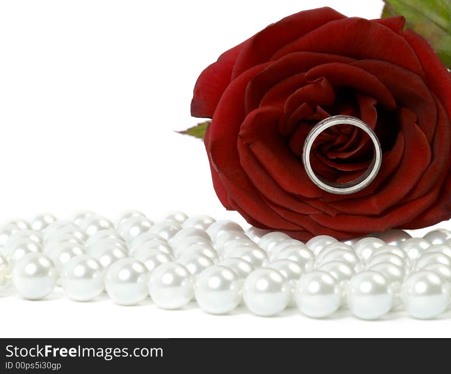 Beautiful red rose with ring lying on pearls. Beautiful red rose with ring lying on pearls