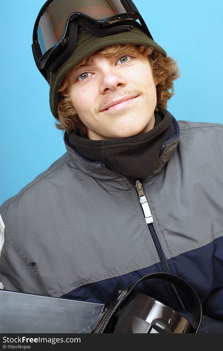 Happy and smiling teenage snowboarder in his gear. Happy and smiling teenage snowboarder in his gear