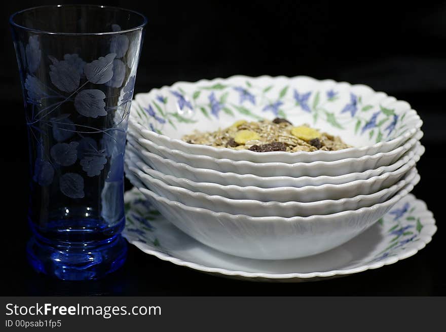 Several white plates of those standing on the black table. Several white plates of those standing on the black table