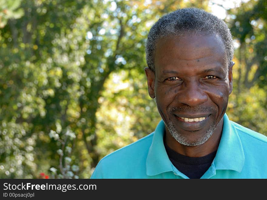 Happy mature man looking relaxed in garden. Happy mature man looking relaxed in garden