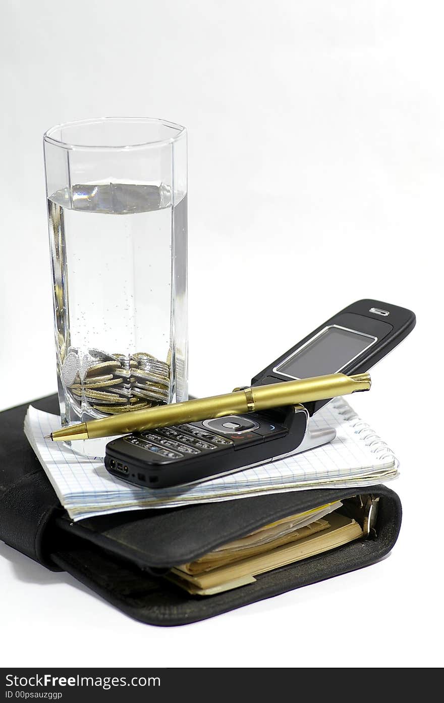 Two notebooks, knob, telephone and container with the pure water