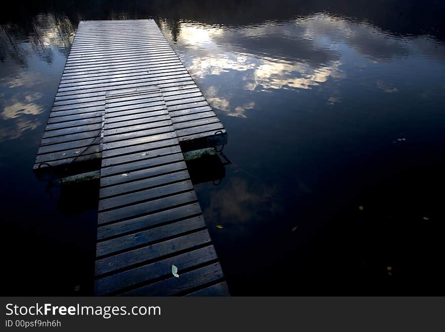 Abandoned wooden pier at sunset