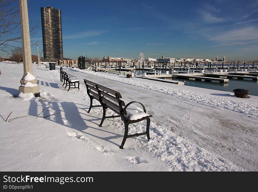 Empty Snowy Bench in Chicago After Winter Snow Along Lake Shore Drive.