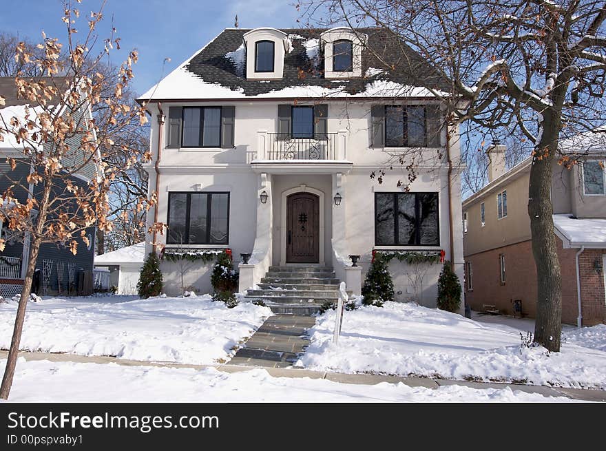 New Home Facade and driveway on a snowy Winter Day. New Home Facade and driveway on a snowy Winter Day