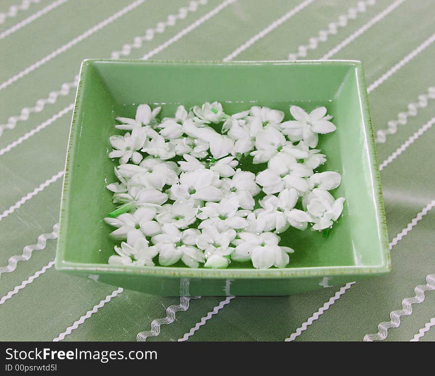 Tropical white flowers floating in water at a spa. Tropical white flowers floating in water at a spa.