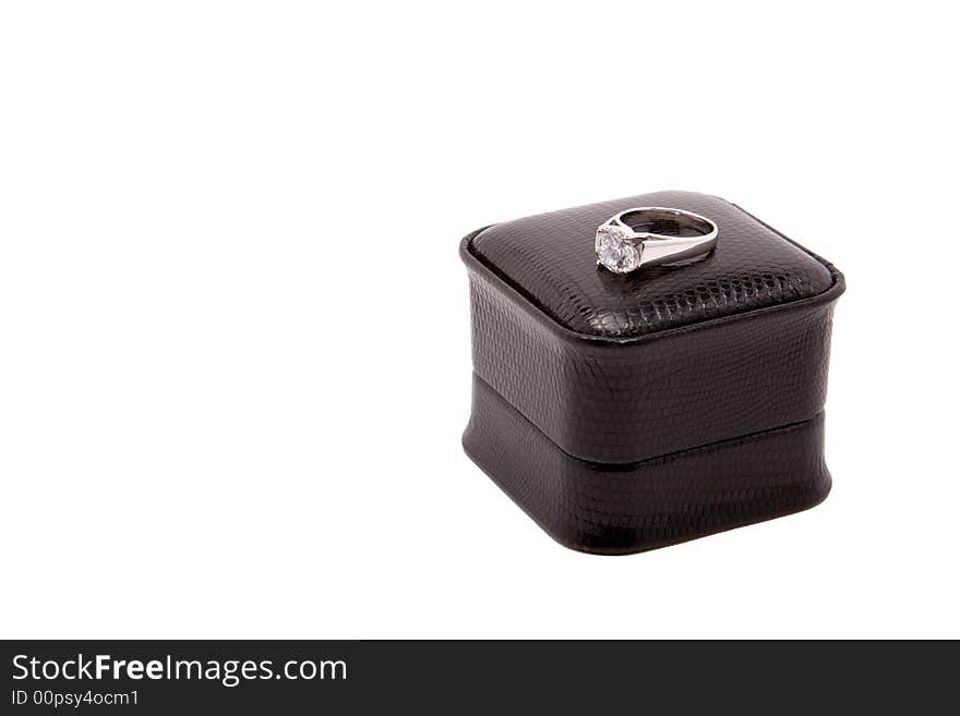 Large diamond encagement ring set in white gold, sitting on top of black box, isolated on white background. Large diamond encagement ring set in white gold, sitting on top of black box, isolated on white background.