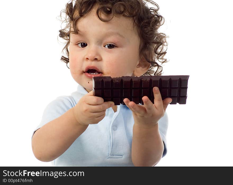 Child eats chocolate, isolated on a white background. Child eats chocolate, isolated on a white background.