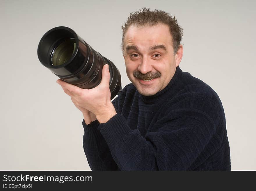 Portrait of a photographer taking pictures with a telephoto lens