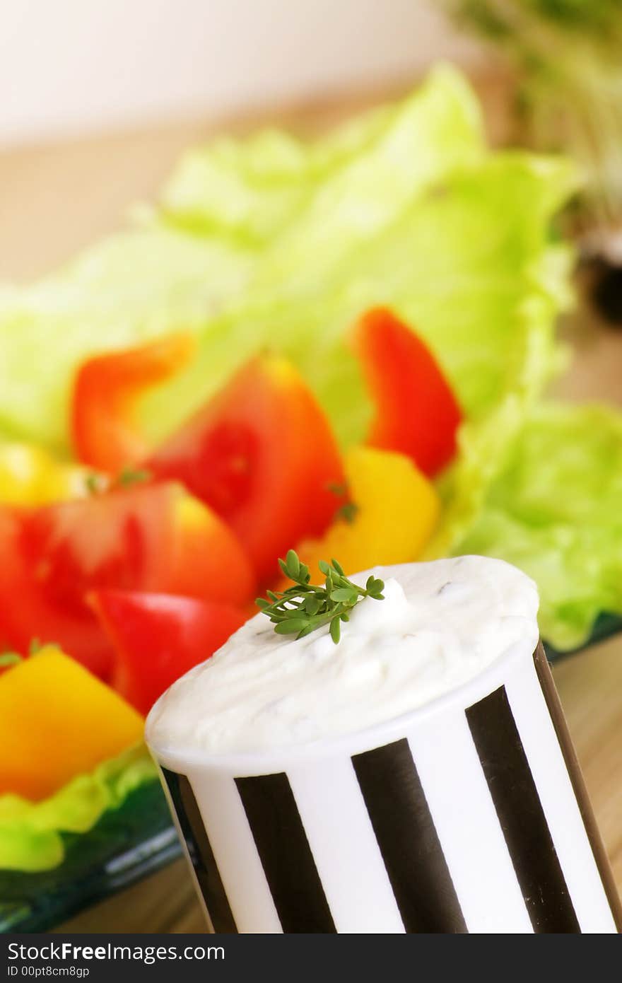 Resh salad with tomatoes and pepper behind cream cheese. Resh salad with tomatoes and pepper behind cream cheese