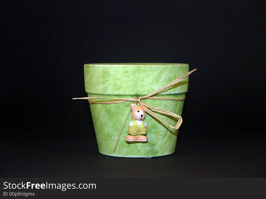 Green flower pot with a black background