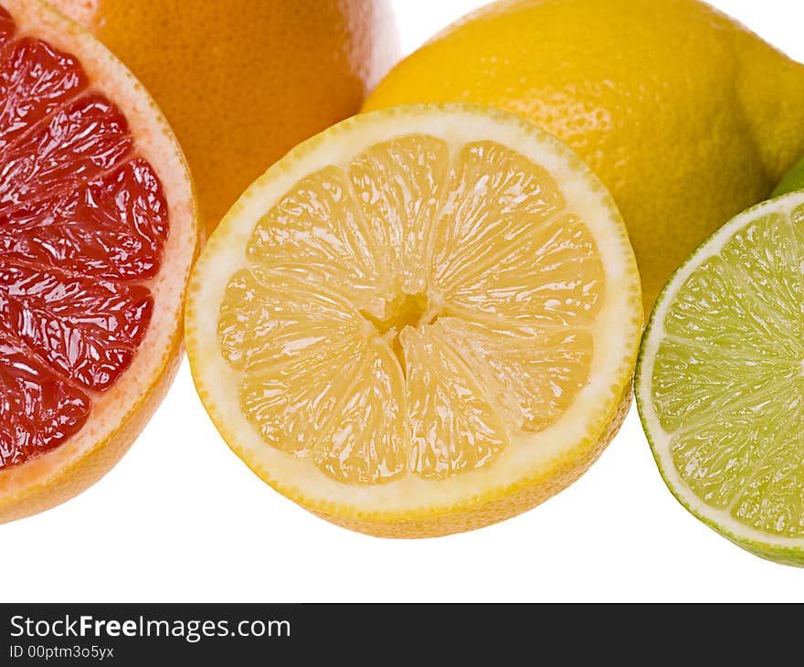 Set of slices of citrus fruits isolated on the white background. Focus on the lemon slice. Set of slices of citrus fruits isolated on the white background. Focus on the lemon slice.