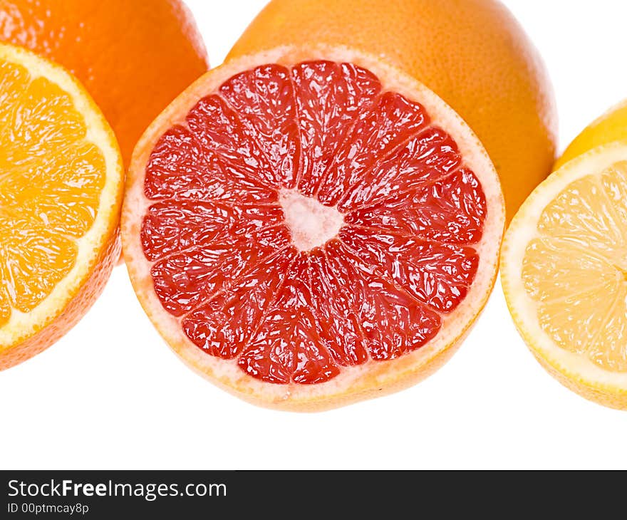 Set of slices of citrus fruits isolated on the white background. Focus on the grapefruit slice. Set of slices of citrus fruits isolated on the white background. Focus on the grapefruit slice.