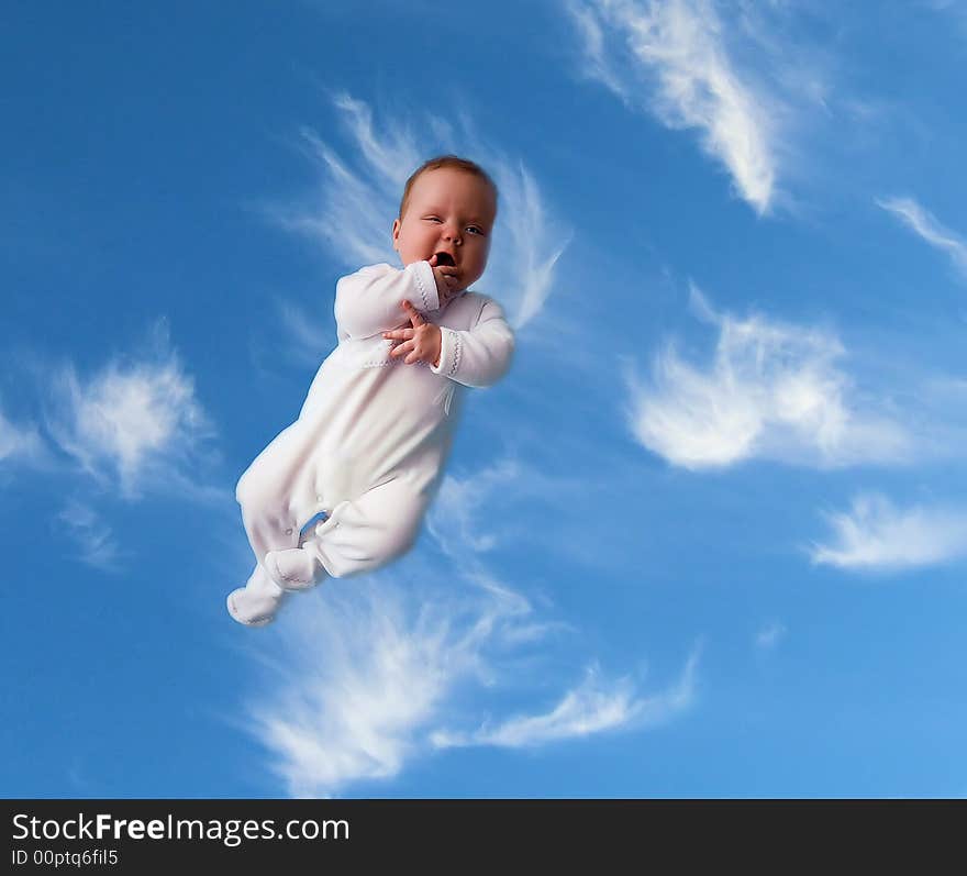 A baby floating in the sky like an angel. A baby floating in the sky like an angel