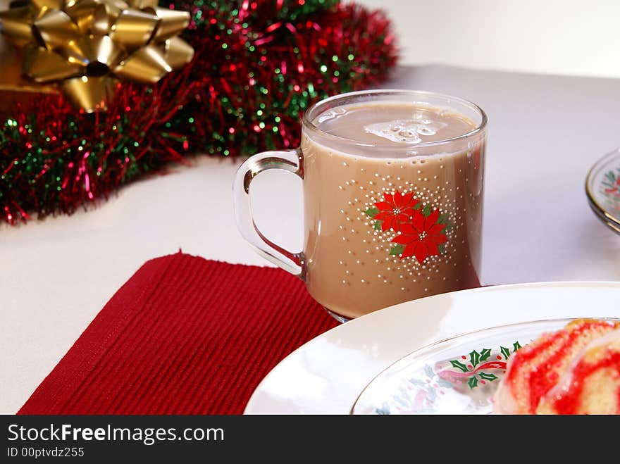 Hot cocoa or chocolate milk in festive Christmas glass mug.