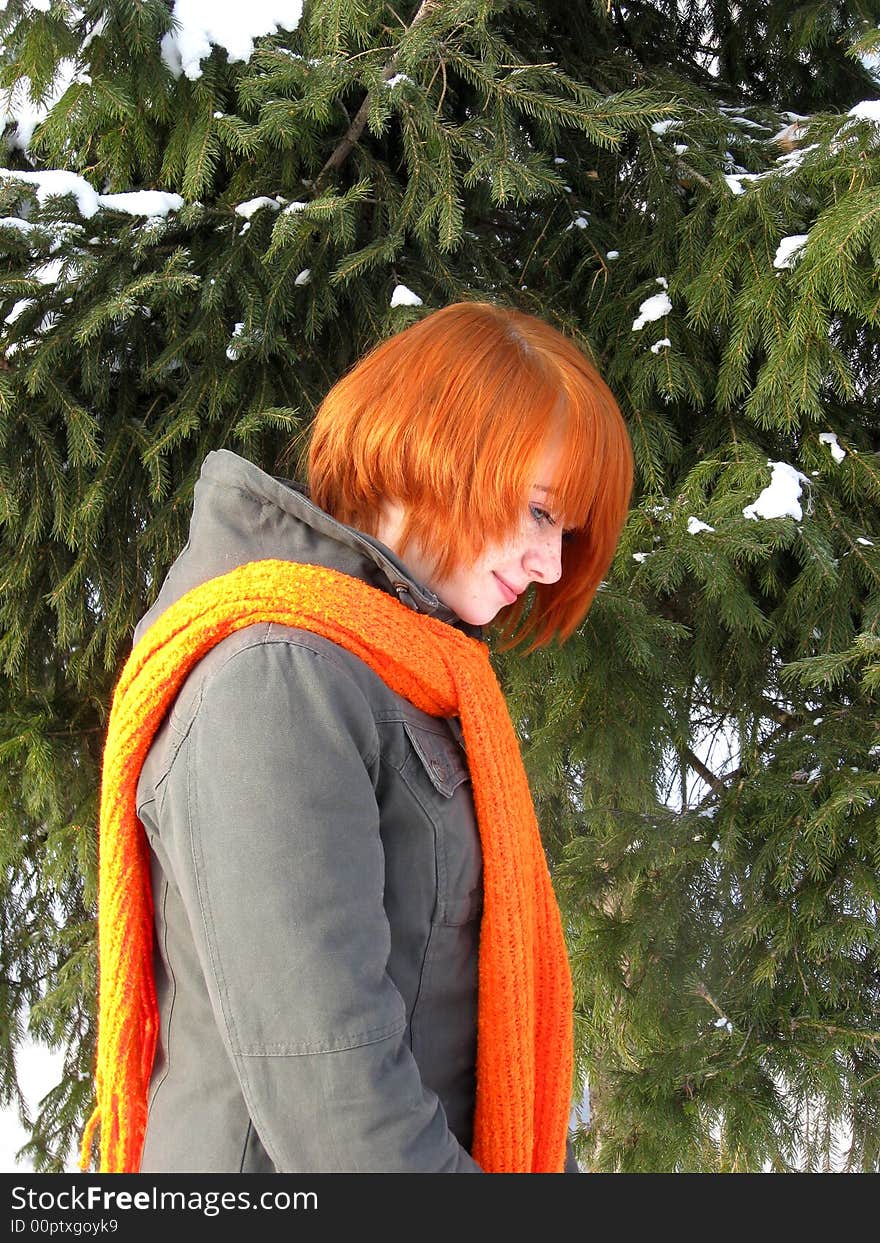 Red-haired girl with orange scarf and green fir