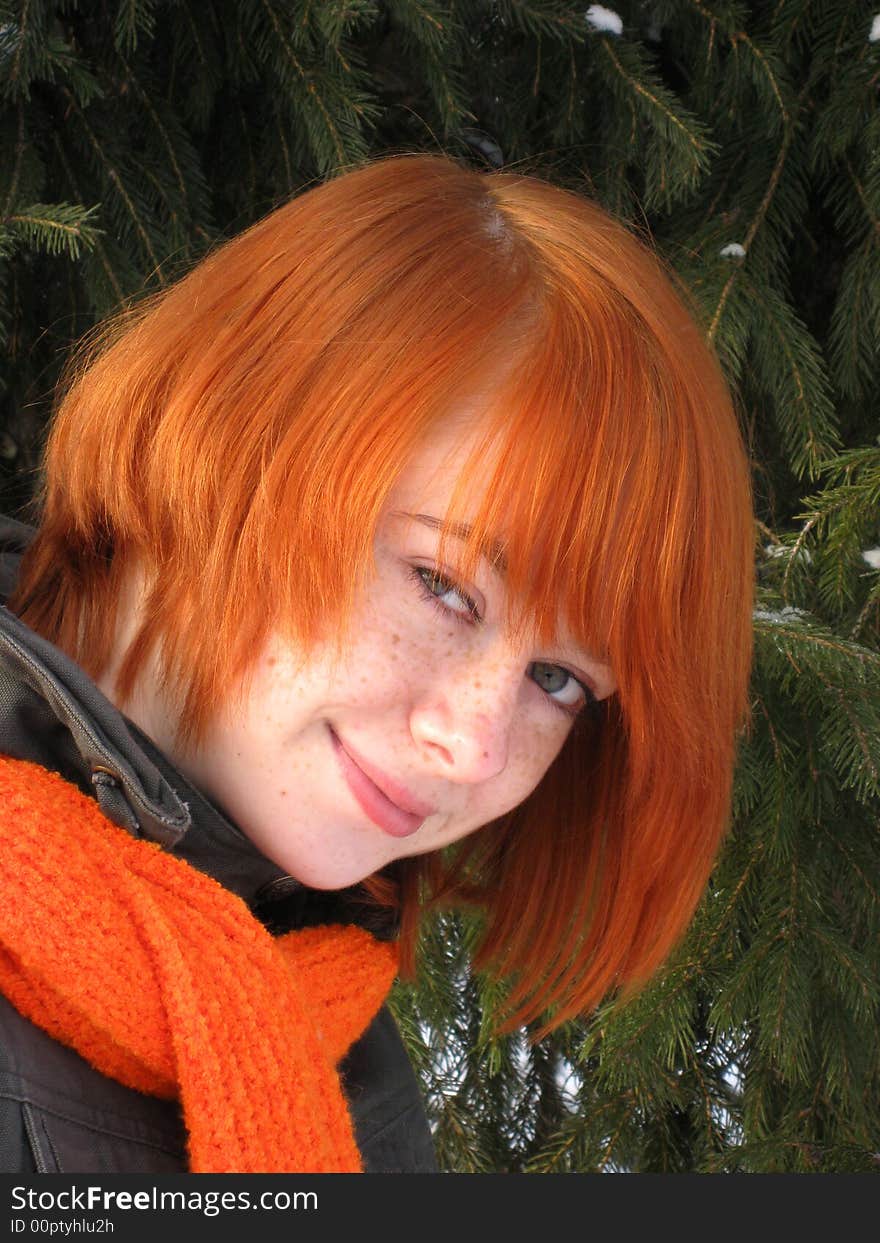 Red-haired girl with orange scarf and green fir