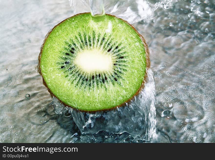 Fresh kiwi jumping into water