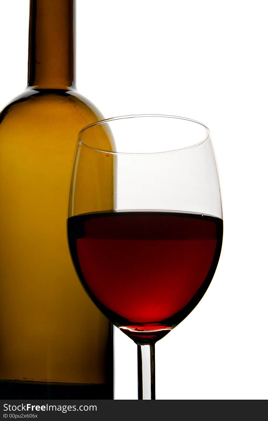 Bottle and glass of red wine isolated