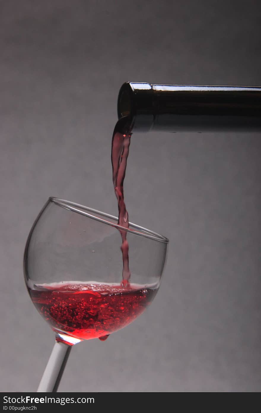 Pouring a glass of wine.