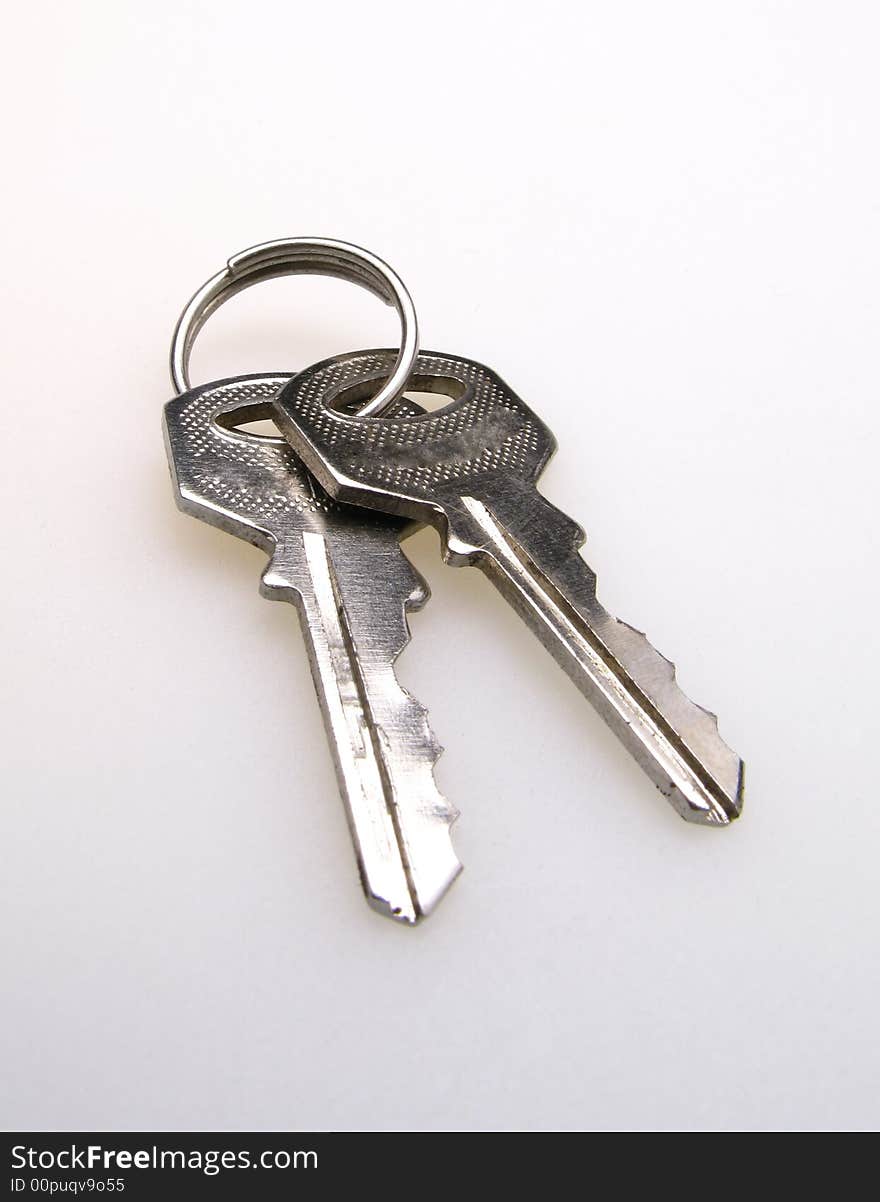 Two keys on light background, close up