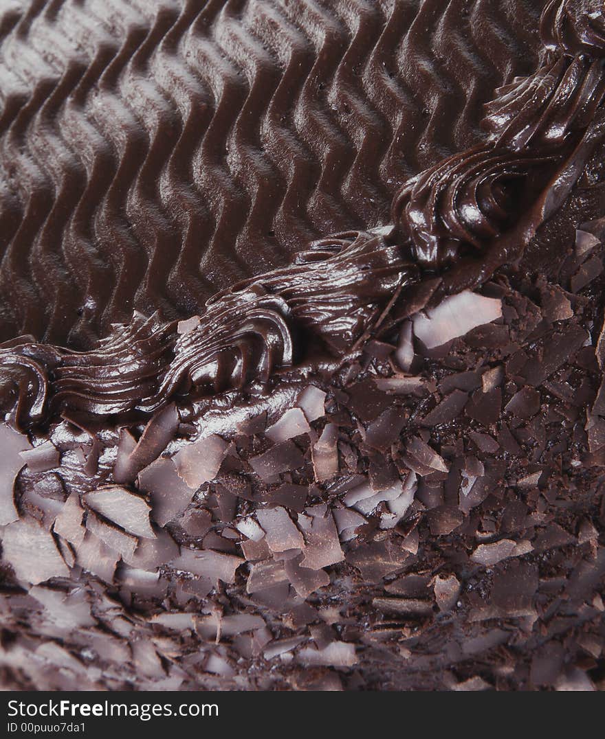 Close up of chocolate cake with rich frosting- shallow depth of focus. Close up of chocolate cake with rich frosting- shallow depth of focus