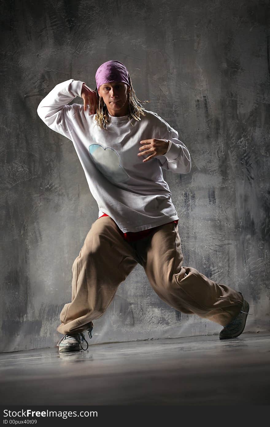 The dancer posing on a dark grey background