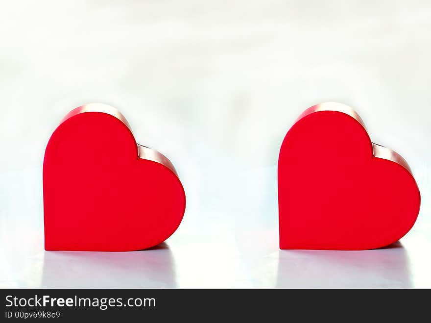 Two hearts over white background