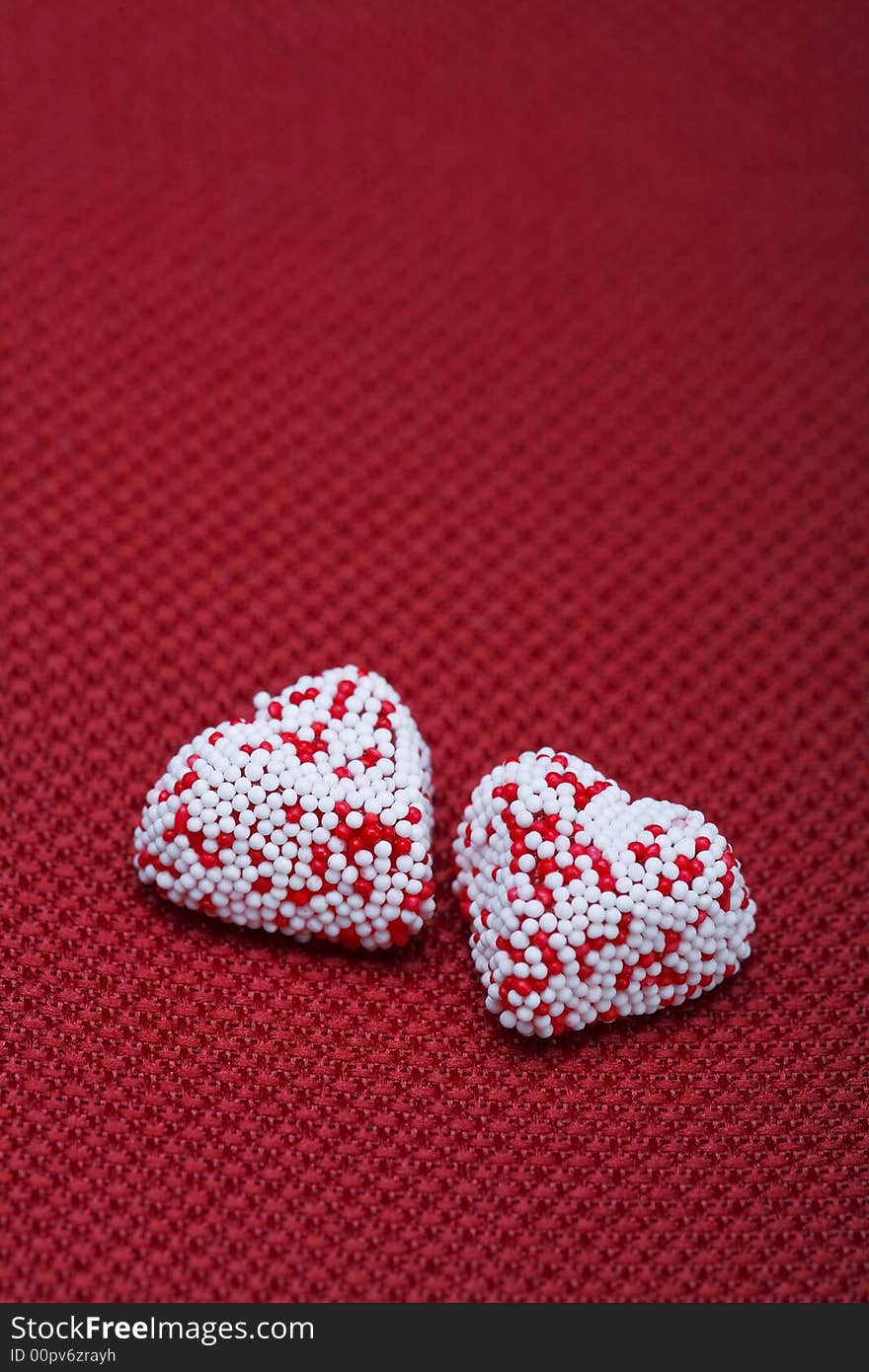 A Couple of Valentine heart candy over red background. A Couple of Valentine heart candy over red background