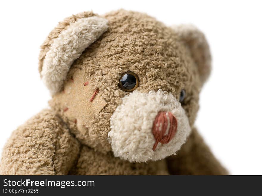 Patched teddy bear portrait - selective focus on the eye. Patched teddy bear portrait - selective focus on the eye.