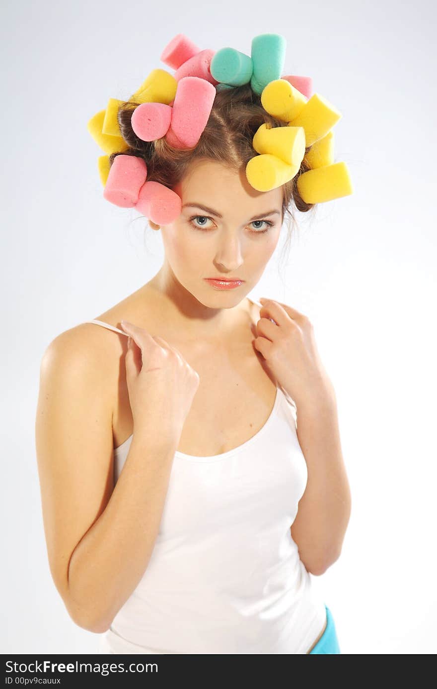 A woman in hair curlers