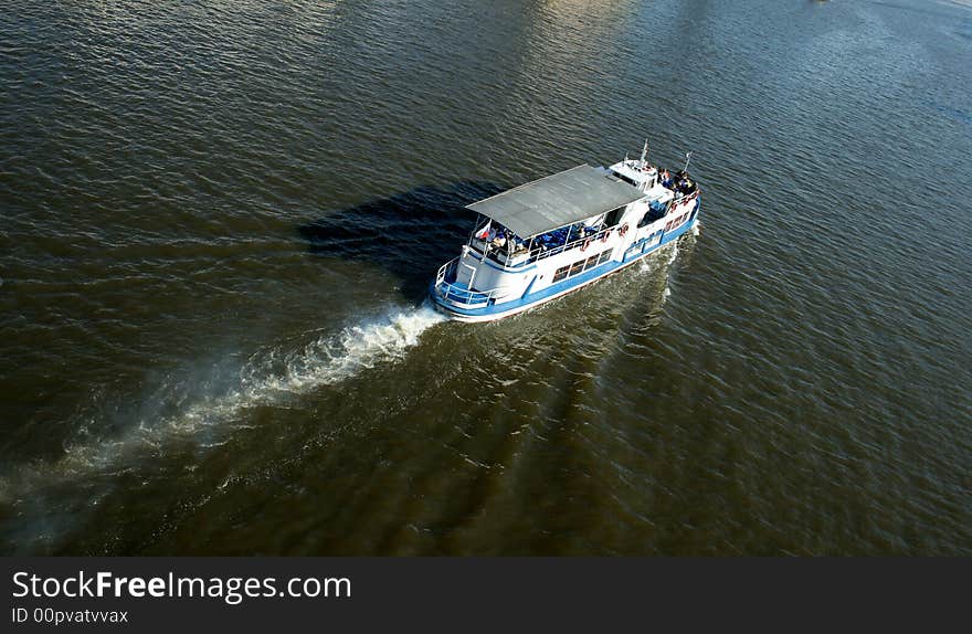 View on river with a tourist ship.