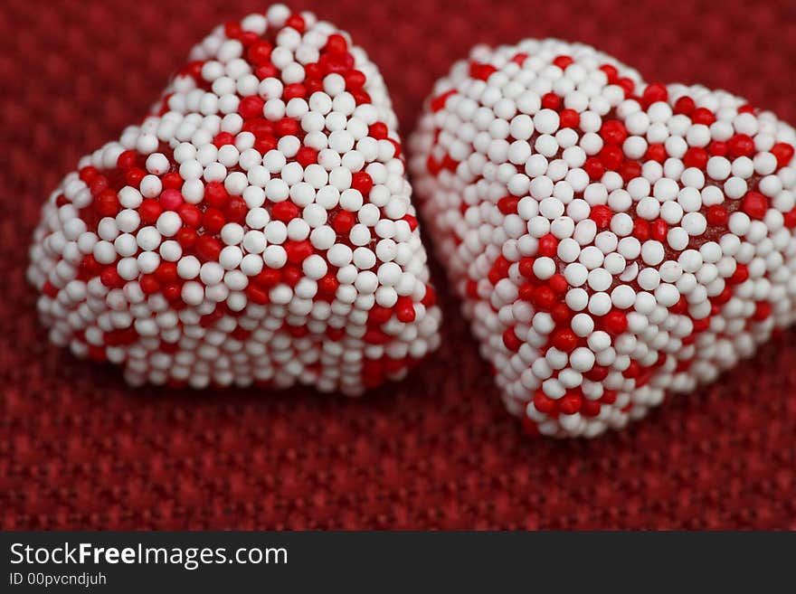 A Couple of Valentine heart candy over red background. A Couple of Valentine heart candy over red background