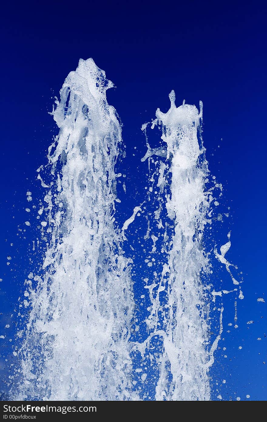 Fountain of water on a background of the blue sky. Fountain of water on a background of the blue sky