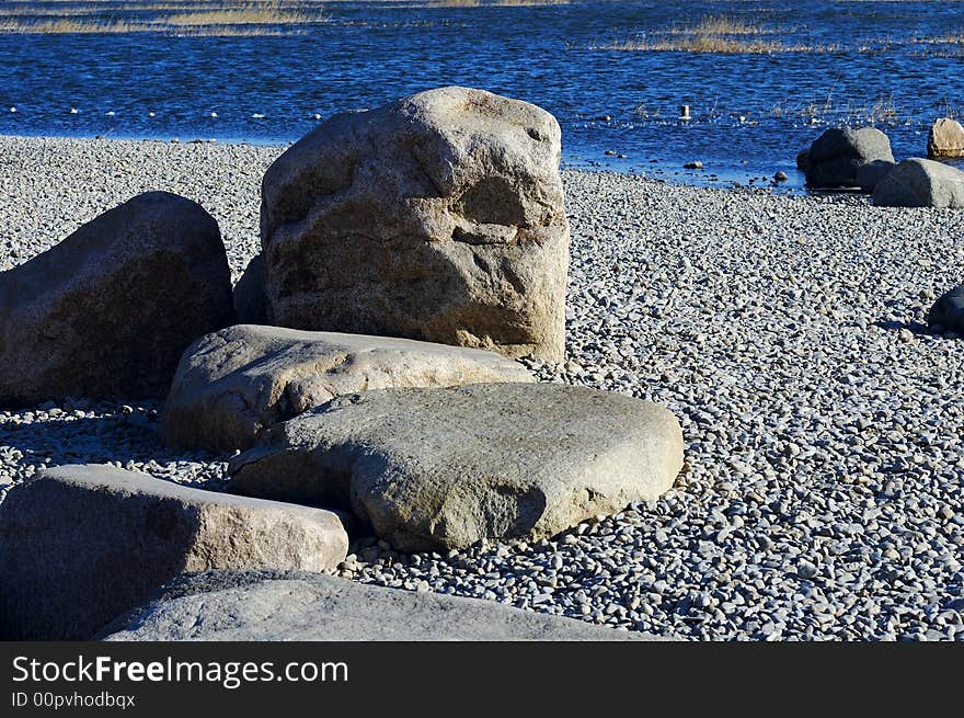 Stone on the winter lake shore