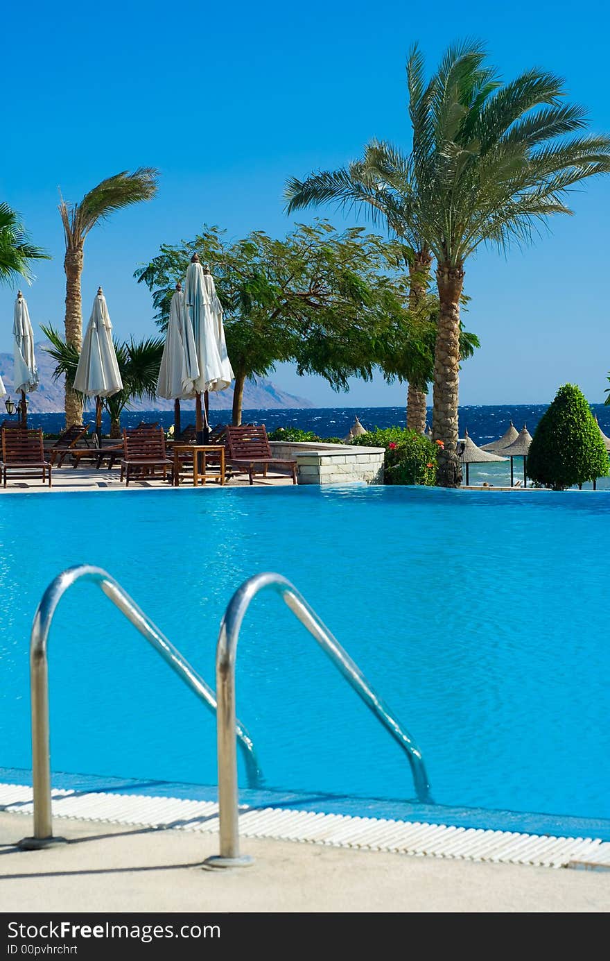 Beautiful swimming pool and ocean in background