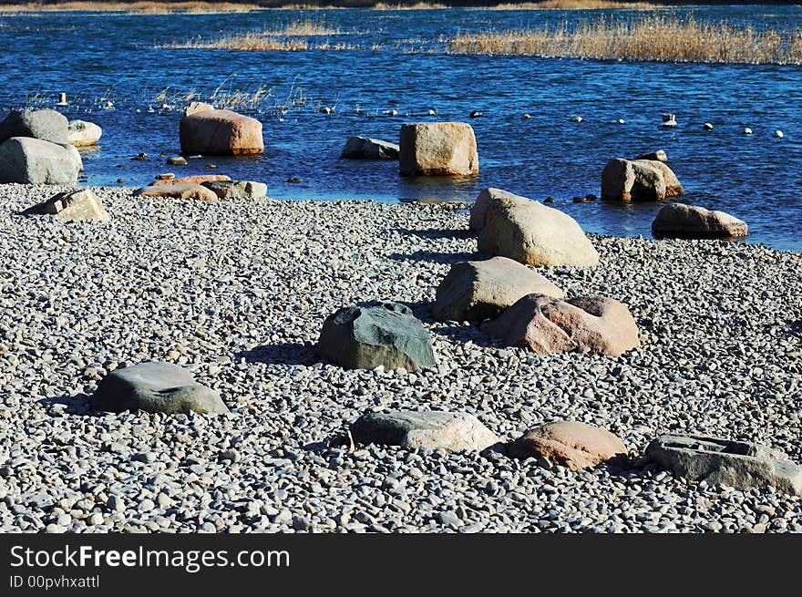 Stones on the winter lake shore