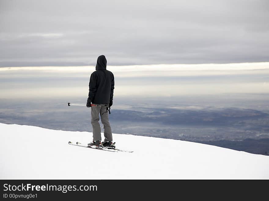 A lone skier on a empty ski slope