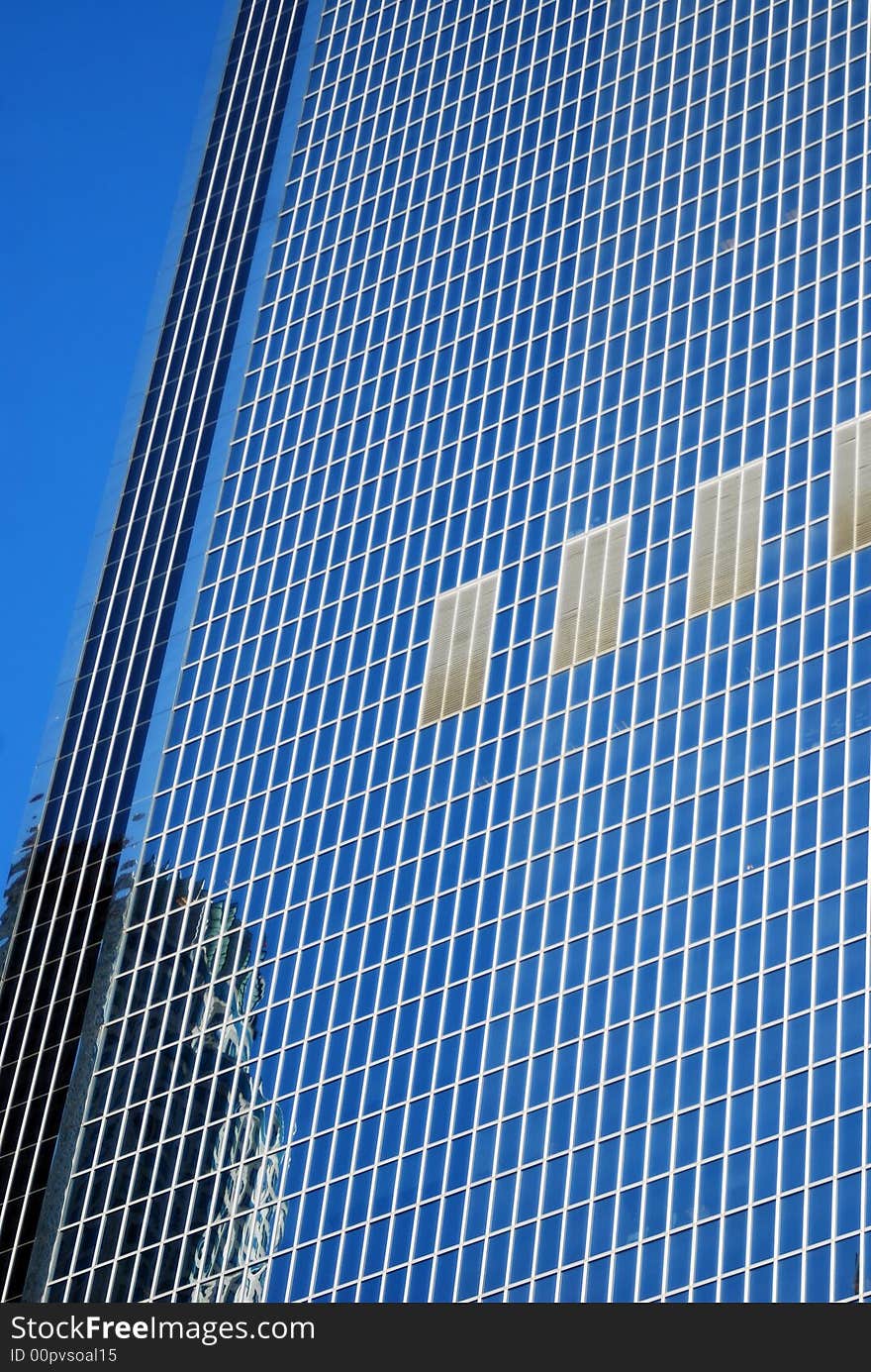 Abstract blue background of modern glass building on a clear sunny day. Abstract blue background of modern glass building on a clear sunny day.